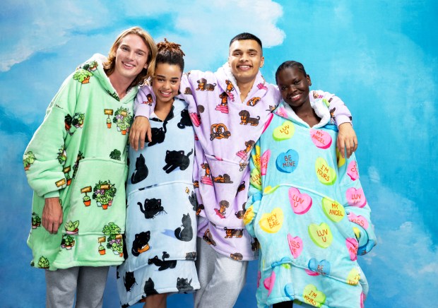 a group of people wearing blankets with candy hearts on them