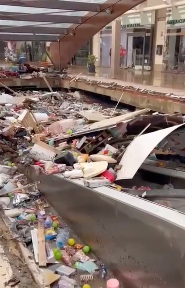 Footage shows the space for car parking below the centre filled to the brim with water and items on Saturday