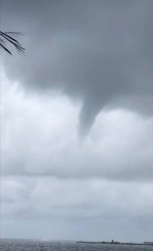 The waterspout pictured approaching a  beach in Marbella today