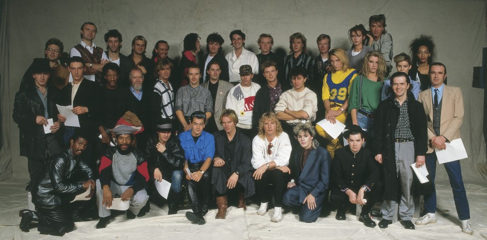 a group of people posing for a picture with one wearing a number 29 jersey