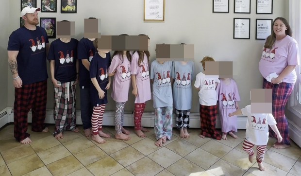 a family standing in a room with their faces covered by cardboard boxes