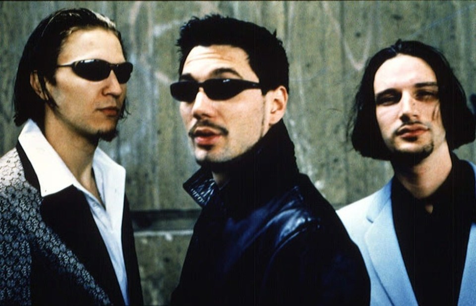 a group of three men wearing sunglasses and a white shirt