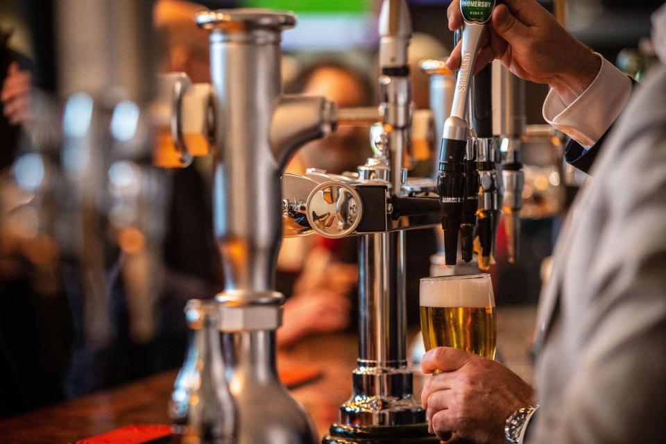 Bartender pouring a pint of beer.