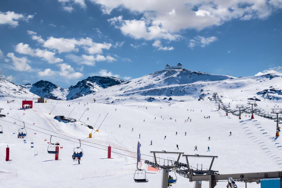 a ski lift going up a snow covered mountain