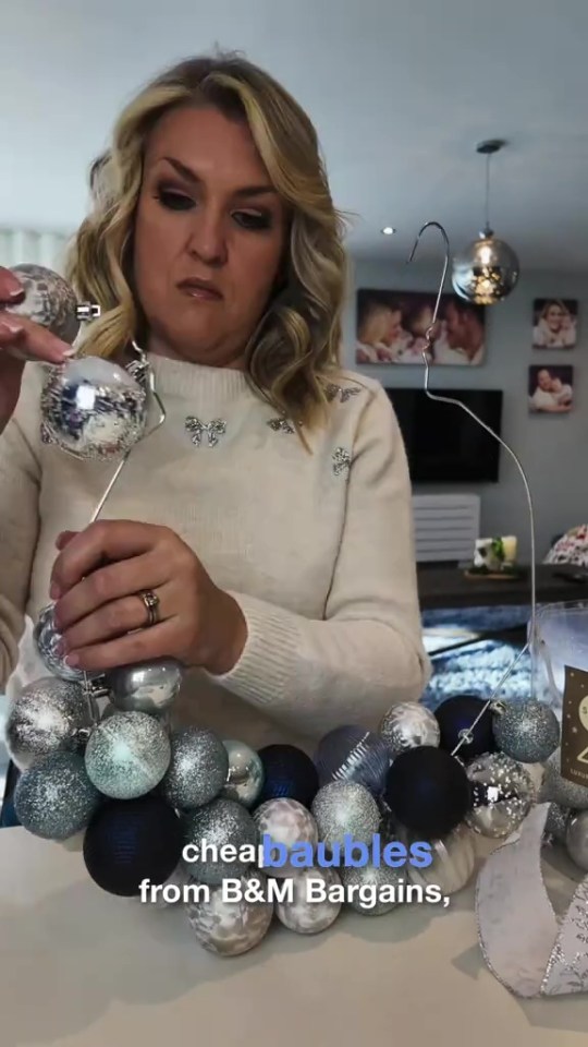 She weaves baubles that she bought from B&M onto the wire hanger