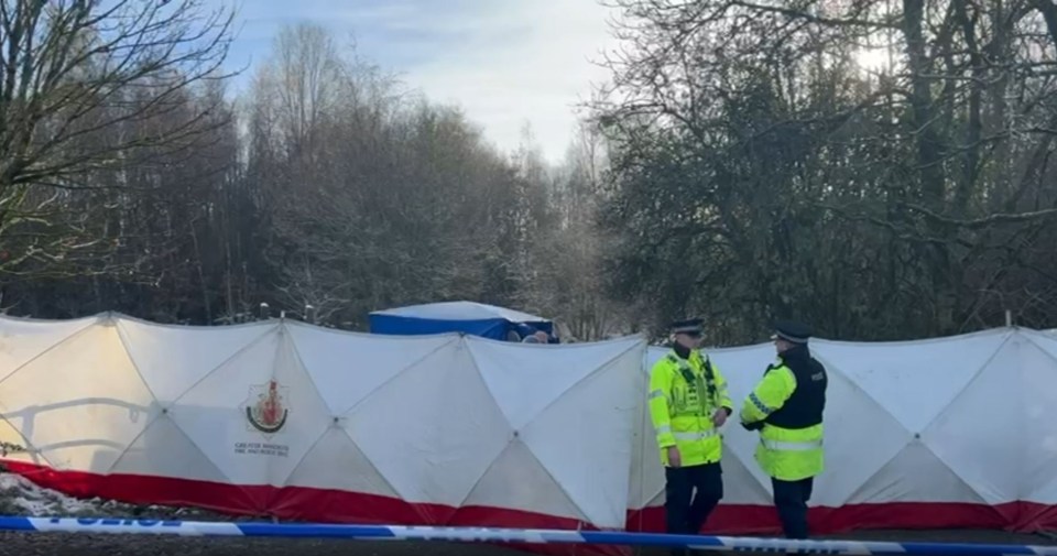 two police officers are standing in front of a white tent that says ' police ' on it