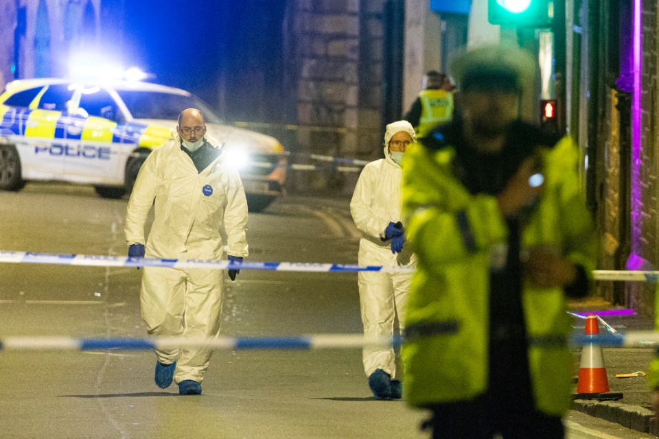 Forensic officers inside a police cordon at the scene