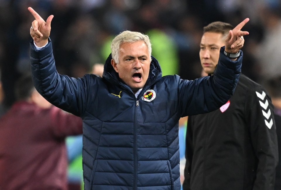 a man in a blue jacket with the word fenerbahce on it