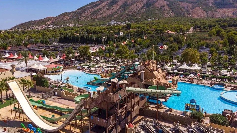 an aerial view of a water park with a castle in the middle