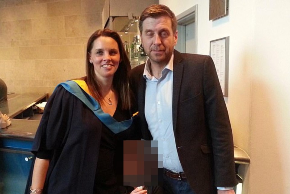 a woman in a graduation cap and gown poses with a man in a suit