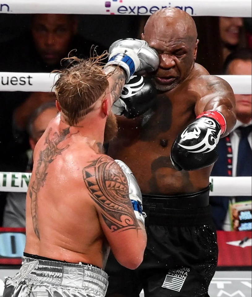 mike tyson and jake paul fight in a boxing ring