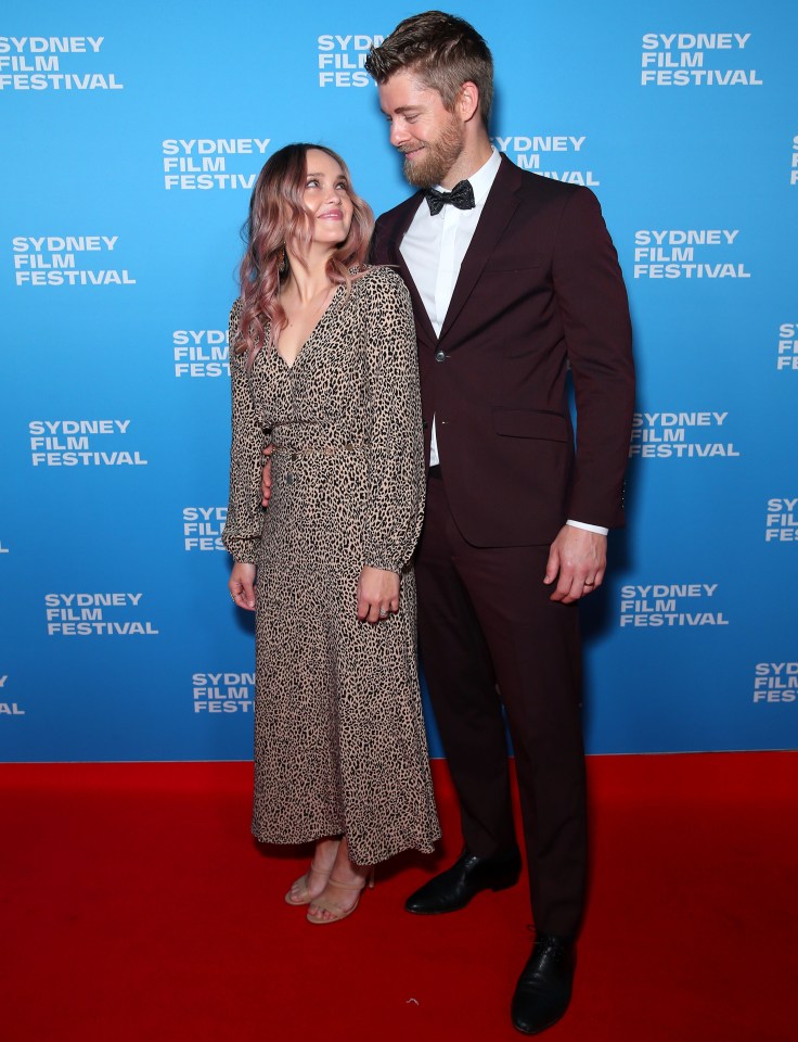 a man and woman pose on a red carpet at the sydney film festival