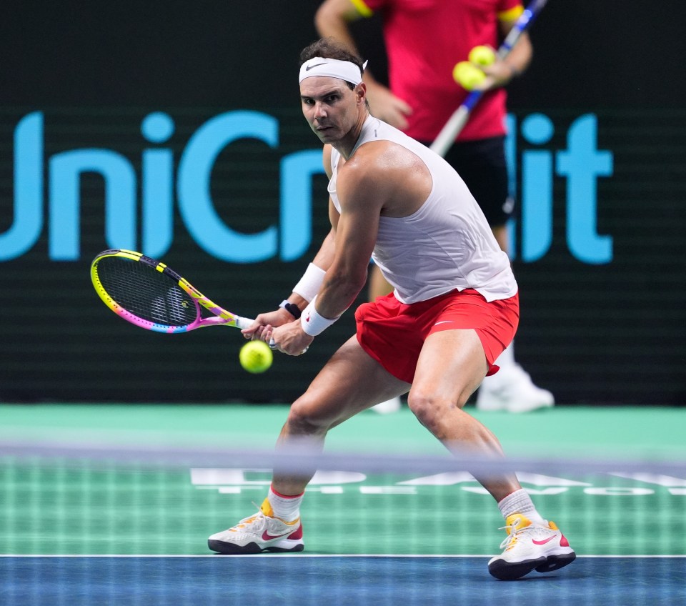 a man playing tennis in front of a sign that says unicredit