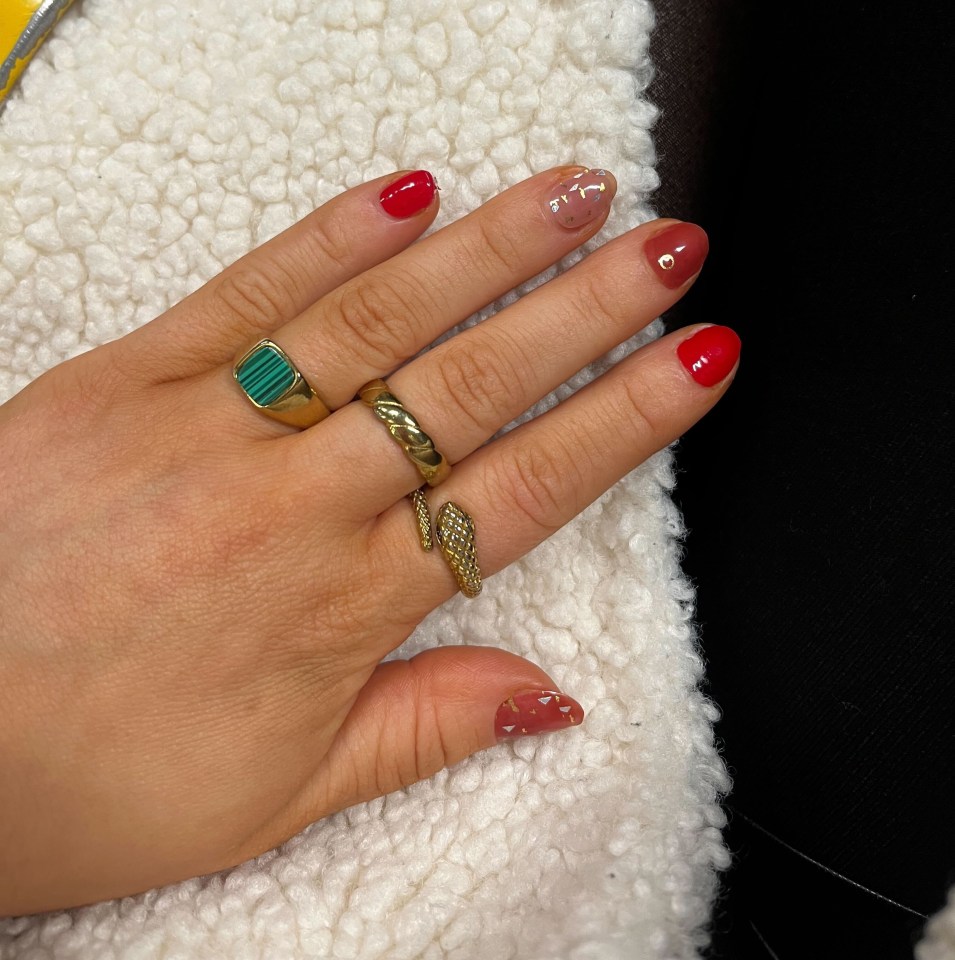 a close up of a person 's nails with rings on them