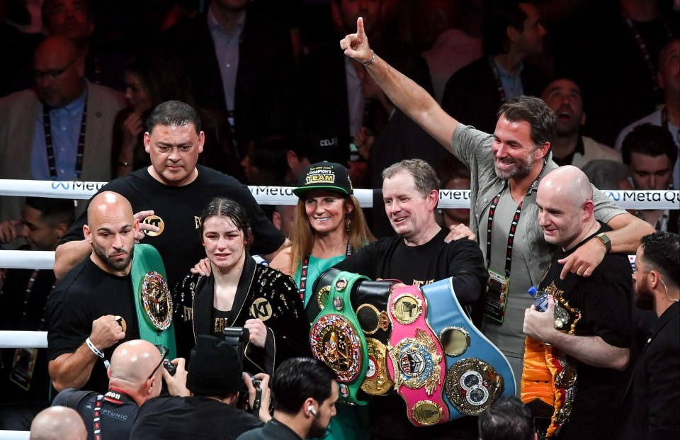 a group of people in a boxing ring with one wearing a hat that says ' king ' on it