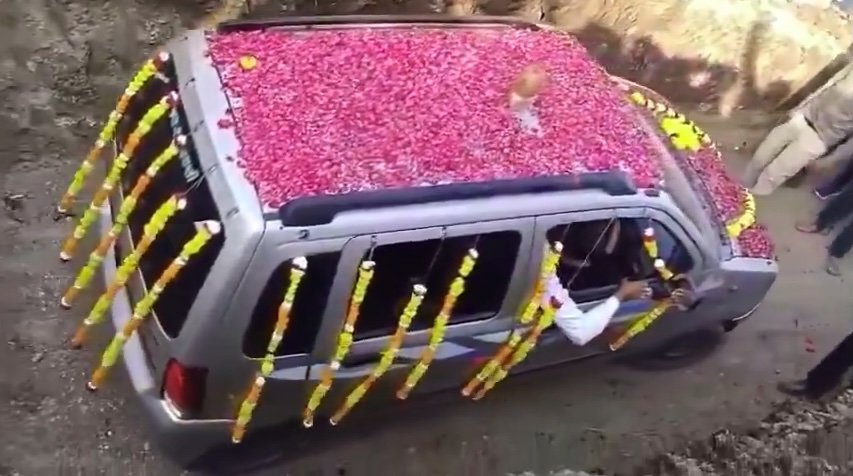 The car was adorned with beautiful flowers to pay respect