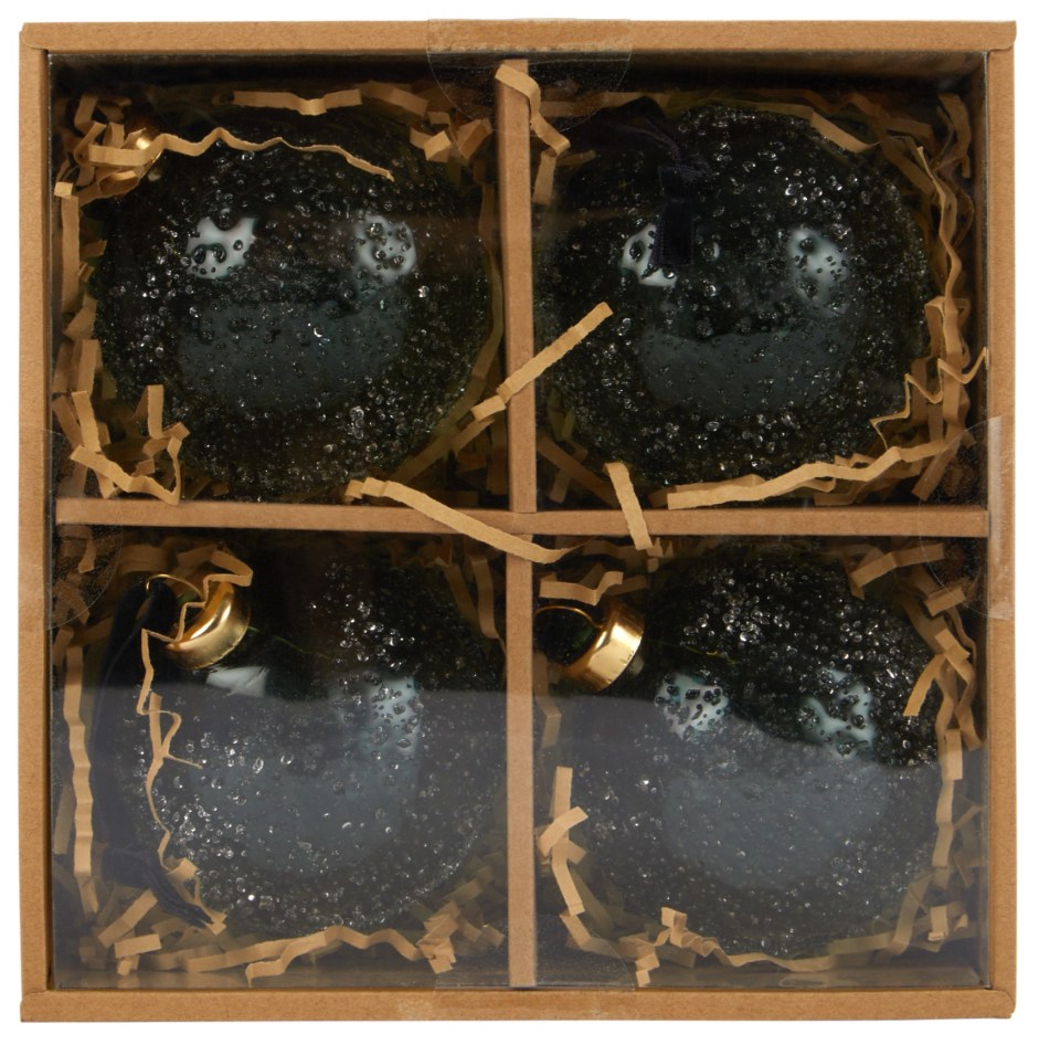 a box with four black christmas ornaments in it