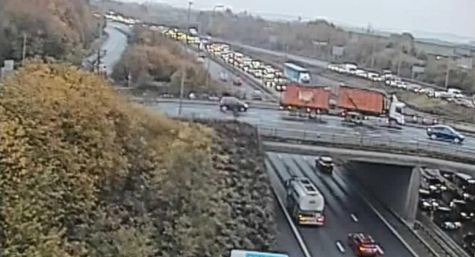 a busy highway with a lot of cars driving down it .