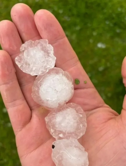 a person is holding three pieces of ice in their hand