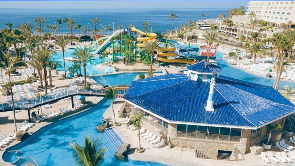 an aerial view of a water park with a blue roof