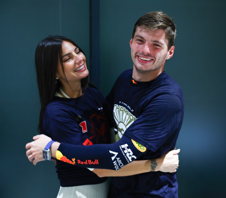 a man and a woman are hugging and the man is wearing a shirt that says red bull