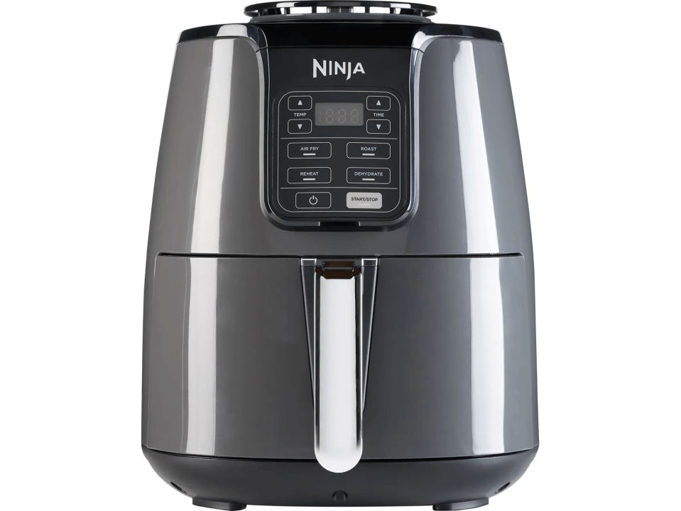 a ninja air fryer with a green background