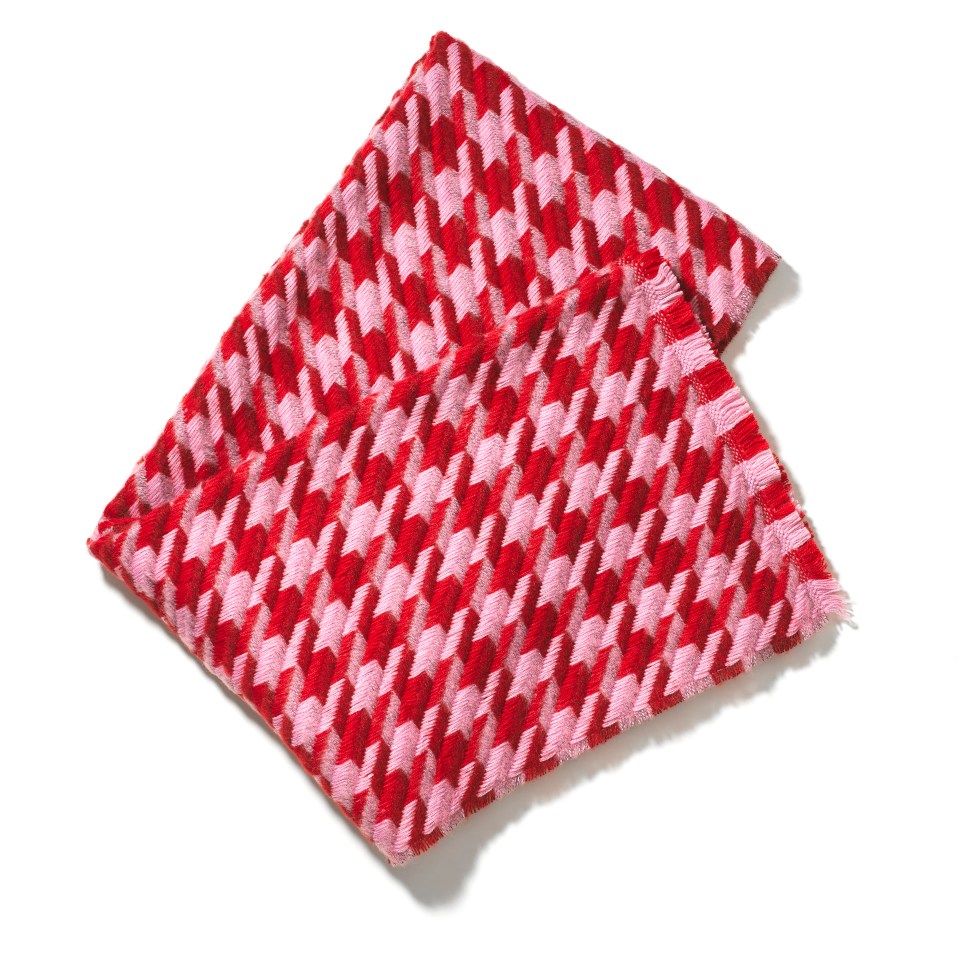 a red and pink scarf with a houndstooth pattern