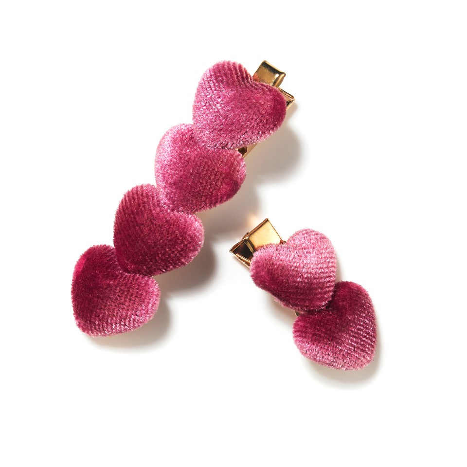 a pair of hair clips with pink hearts on them