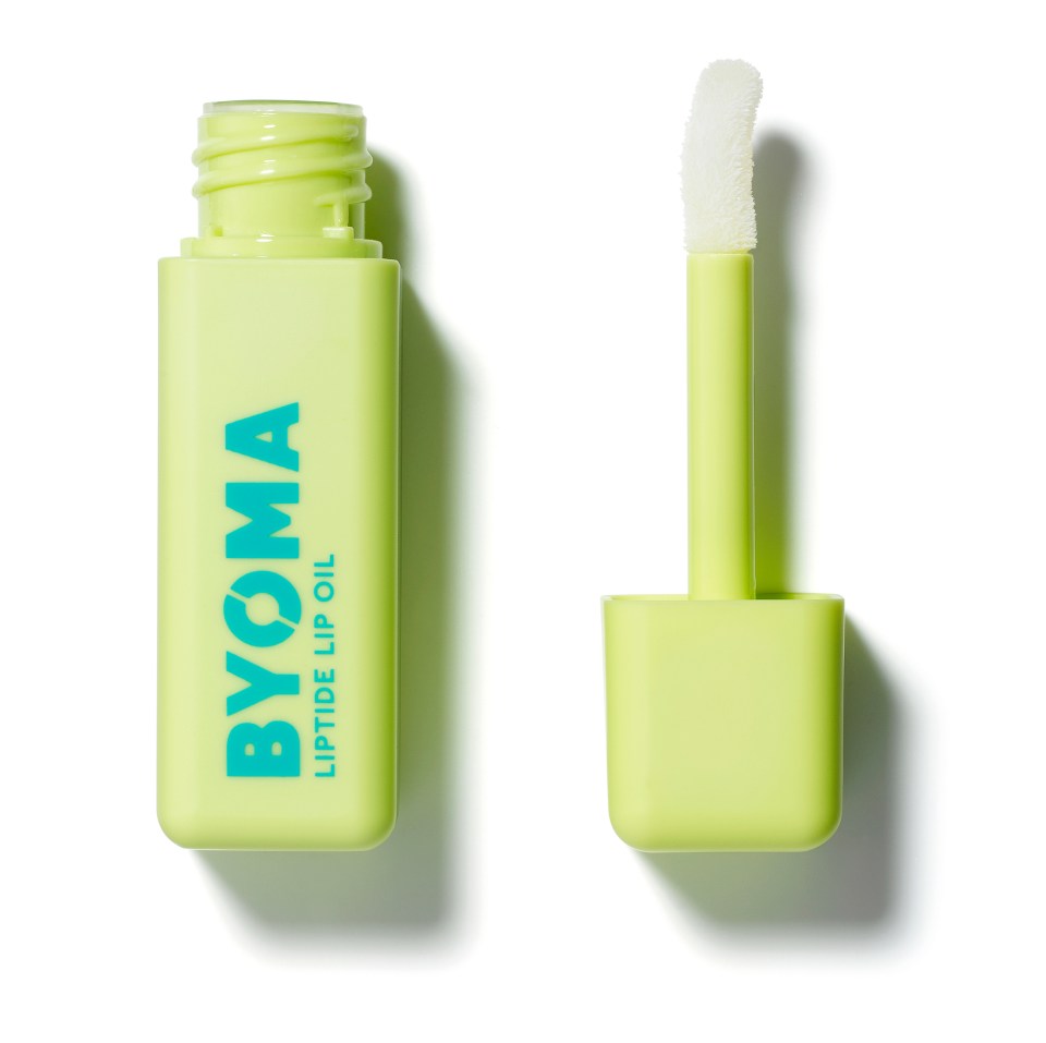 a bottle of byoma liptide lip oil next to its applicator