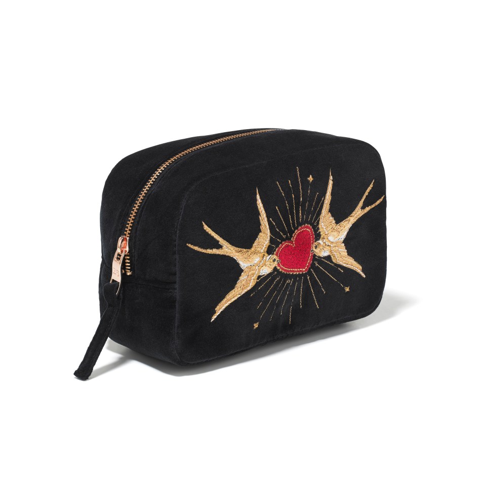 a black bag with swallows and a heart embroidered on it