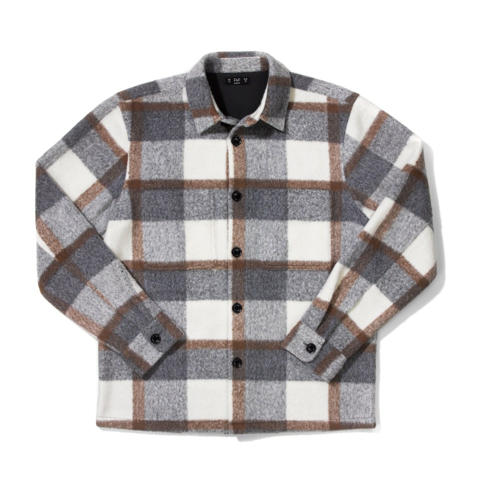 a plaid shirt with a black label that says ' i am v ' on it