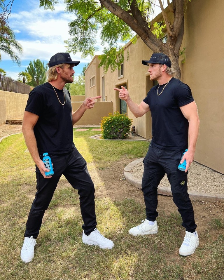 two men standing next to each other with one holding a bottle that says ' gatorade ' on it