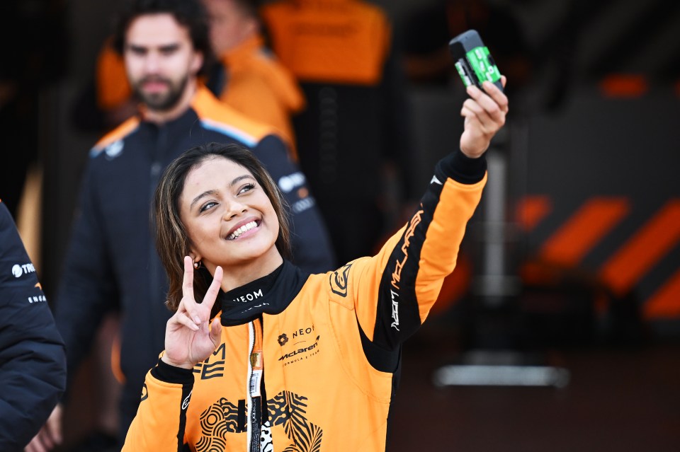 MADRID, SPAIN - NOVEMBER 08: Bianca Bustamante of the Philippines and NEOM McLaren Formula E Team makes a peace sign with her hand as she takes a selfie during day four of Formula E Pre-Season Testing at Circuito del Jarama on November 08, 2024 in Madrid, Spain. (Photo by Simon Galloway/LAT Images for Formula E)