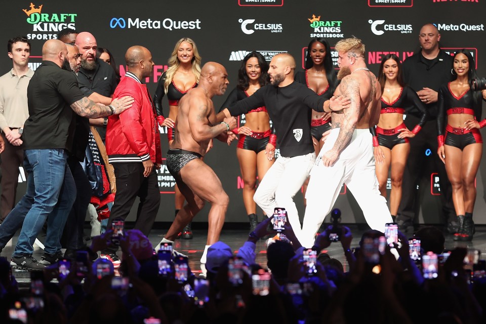 IRVING, TEXAS - NOVEMBER 14: Mike Tyson and Jake Paul are separated as they face off during their ceremonial weigh-in at The Pavilion at Toyota Music Factory on November 14, 2024 in Irving, Texas. The two are scheduled to meet in a heavyweight bout on November 15 at AT&T Stadium in Arlington, Texas. (Photo by Christian Petersen/Getty Images)