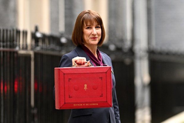 LONDON, ENGLAND - OCTOBER 30: Chancellor of the Exchequer, Rachel Reeves, poses with the red Budget Box as she leaves 11 Downing Street to present the government's annual budget to Parliament on October 30, 2024 in London, England. This is the first Budget presented by the new Labour government and Chancellor of the Exchequer, Rachel Reeves. (Photo by Leon Neal/Getty Images)