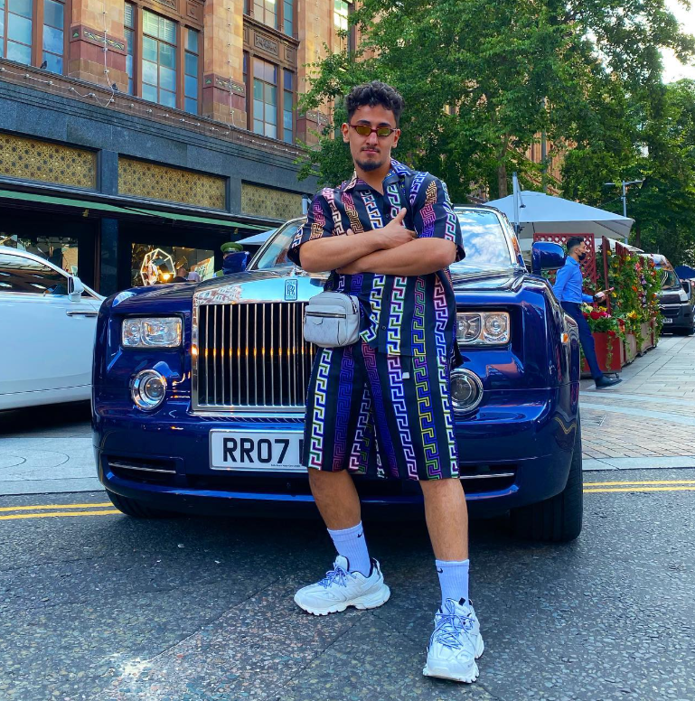 AnEsonGib posing in front of a Rolls Royce posted on Instagram @anesongib.