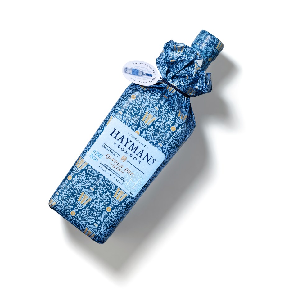 a bottle of haymans london gin is wrapped in blue paper