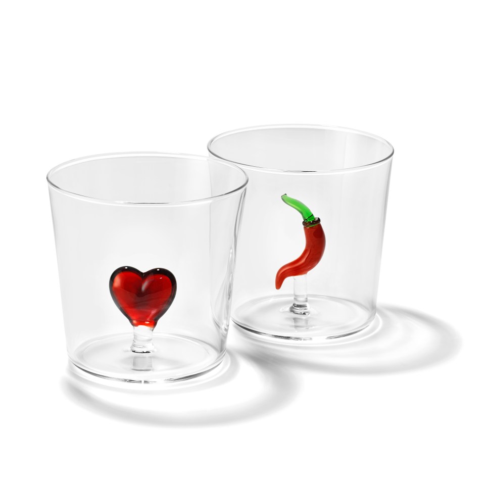 two clear glasses with a red heart and a red pepper on them