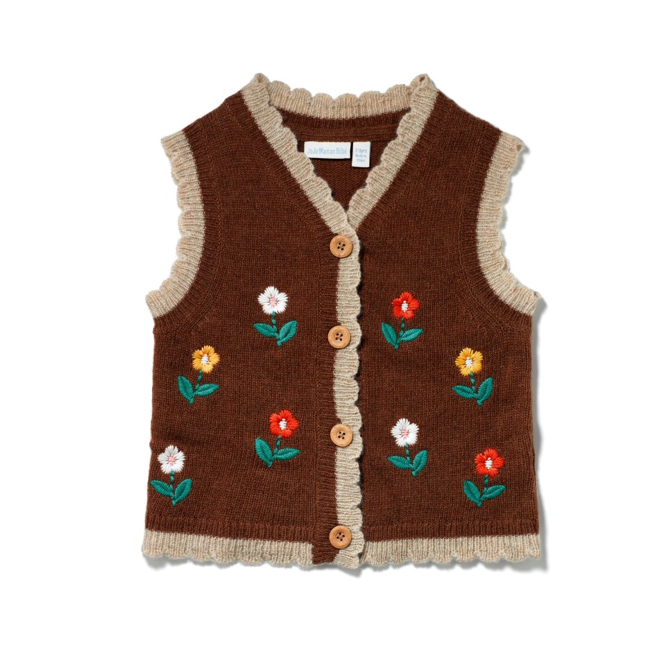 a brown sweater vest with flowers embroidered on it