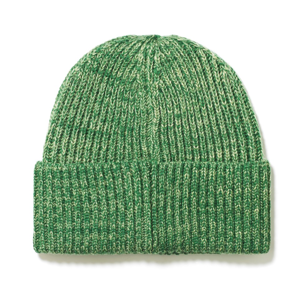 a green and white knitted hat with a white background