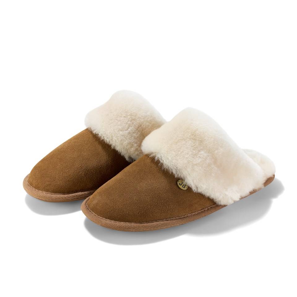 a pair of brown sheepskin slippers with a white cuff