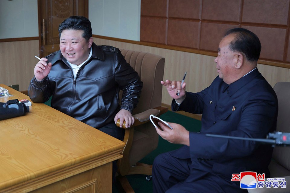 Kim enjoys a smoke as he observes kamikaze drone tests