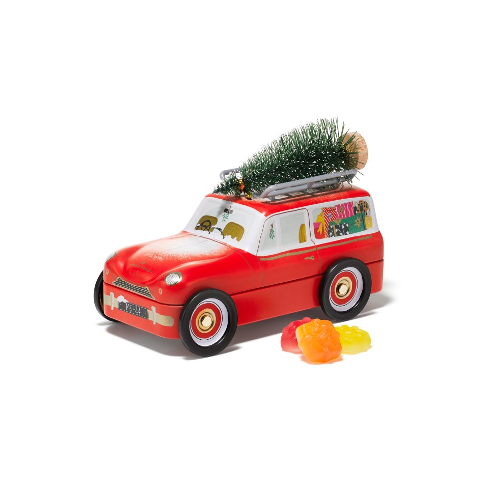 a red toy car with a christmas tree on top of it