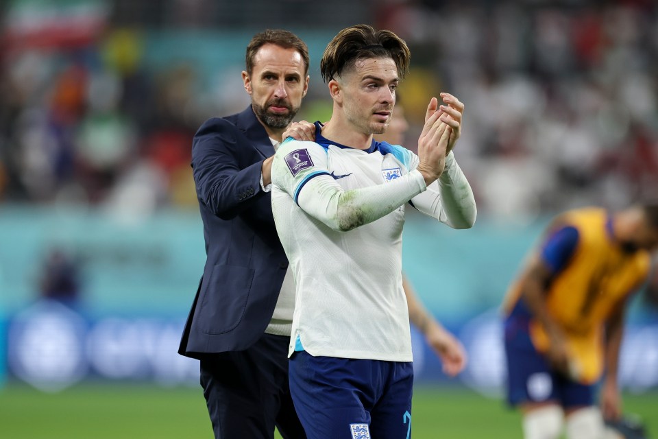 two men on a soccer field one of whom is wearing an england jersey