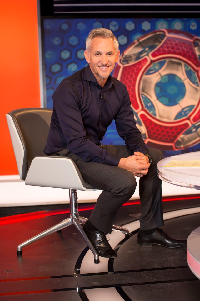 a man sits in a chair in front of a soccer ball