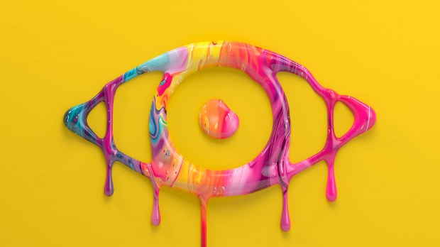 a yellow background with a colorful eye made of paint