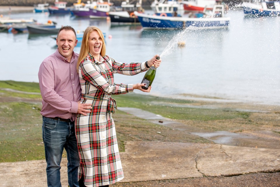 Luke and Alison spraying the champagne