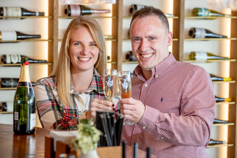 a man and a woman are toasting with champagne glasses