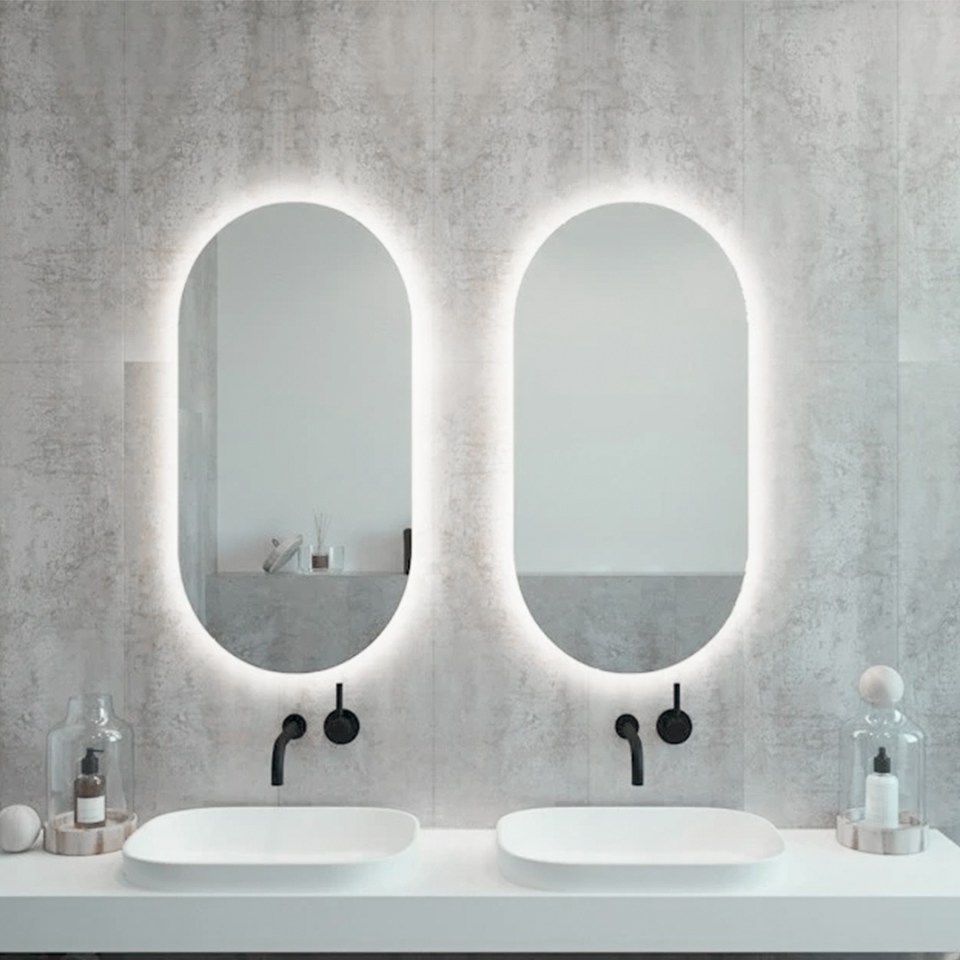 a bathroom with two sinks and two mirrors