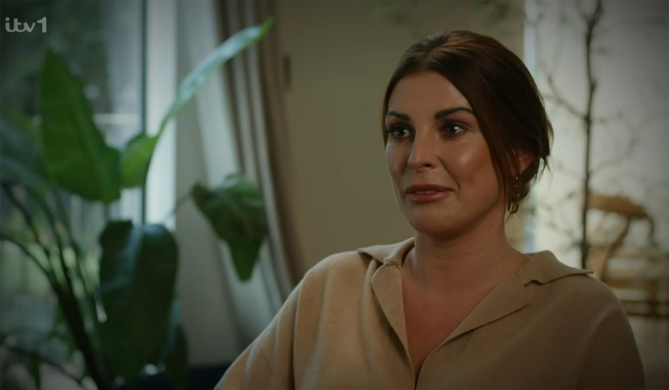 a woman sitting in front of a window with itv1 written on the bottom